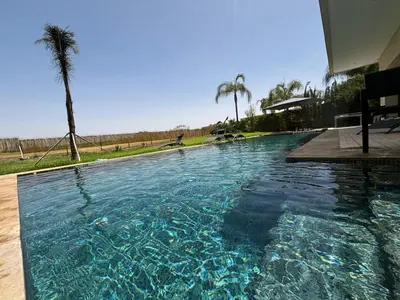 a swimming pool with blue water in a house at M REVASION Appartement Golf27 in Marrakech