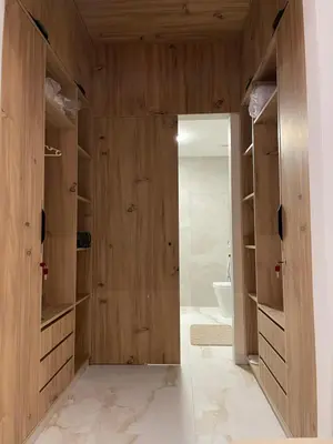 a bathroom with wooden walls and a door with a toilet at M REVASION Appartement Golf27 in Marrakech