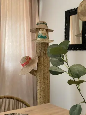 a wooden pole with hats on top of a table at M REVASION Appartement Golf27 in Marrakech
