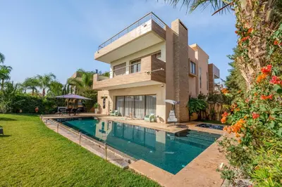 an image of a house with a swimming pool at M REVASION Appartement Golf27 in Marrakech