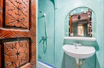 a bathroom with a sink and a mirror at Blue Room in Marrakech