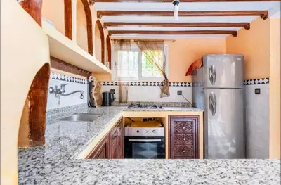 a kitchen with a sink and a refrigerator at Blue Room in Marrakech