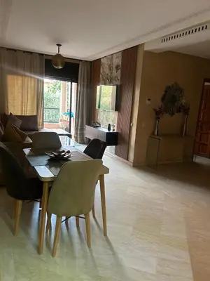 a living room with a table with a laptop on it at Appartements de vacances in Marrakech