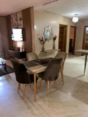 a dining table and chairs in a living room at Appartements de vacances in Marrakech