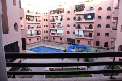 a view from the balcony of a building with a swimming pool at Premium village c1866 in Marrakech