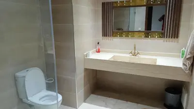 a bathroom with a sink and a toilet and a mirror at Premium village c1866 in Marrakech