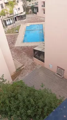 a swimming pool in a yard next to a building at Premium village c1866 in Marrakech