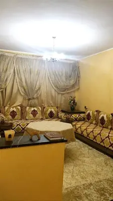 a living room with a couch in front of a window at شقة بمدينة مراكش بقرب جميع المرافق in Marrakech