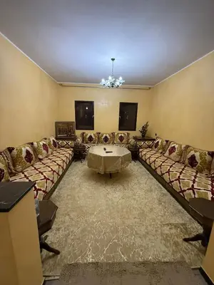 a living room with couches and a table in a room at شقة بمدينة مراكش بقرب جميع المرافق in Marrakech
