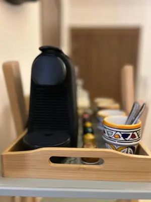 a wooden box with a black item sitting on a table at Le Coup de cœur de Guéliz avec Piscine et Parking in Marrakech