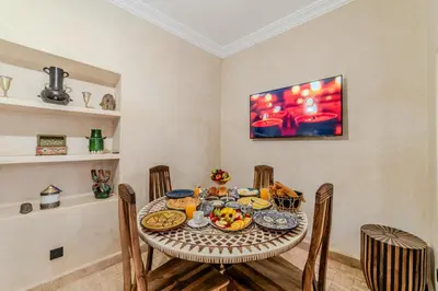 a dining room with a table with food on it at Riad Dar Davia - Jacuzzi Rooftop - Breakfast in Marrakech