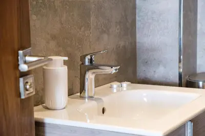 a sink in a bathroom with a faucet at Bright and Stylish Apartment Center of Marrakech in Marrakech