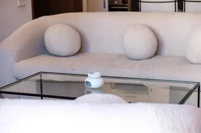 a living room with a couch with a glass coffee table at Bright and Stylish Apartment Center of Marrakech in Marrakech