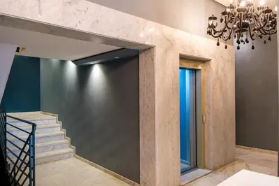 a staircase in a house with a chandelier at Bright and Stylish Apartment Center of Marrakech in Marrakech