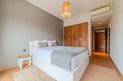 a bedroom with a large white bed in a room at Luxury and Serenity at Noria Golf and Pool in Marrakech