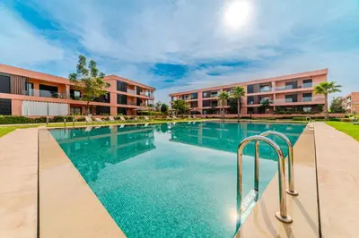 a swimming pool in front of a building at Luxury and Serenity at Noria Golf and Pool in Marrakech