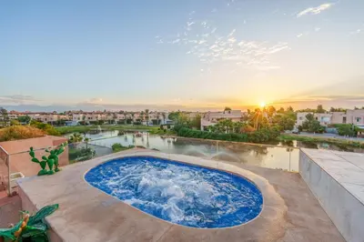 a pool on the roof of a house with the sunset at Spacious Luxury Apartment with Heated Pool Center in Marrakech