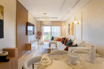 a living room with a couch and a table at Orange apartment in Marrakech