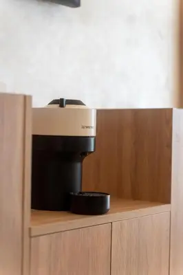 a coffee maker sitting on top of a wooden cabinet at Orange apartment in Marrakech