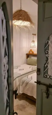 a bedroom with a bed and a table with a lamp at Riad Amaya in Marrakech