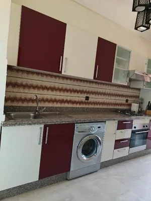 a kitchen with a washing machine and a sink at Séjour Familial à Marrakech in Marrakech
