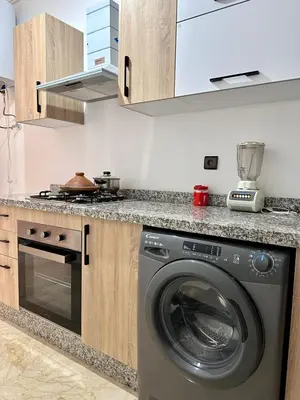 a kitchen with a washing machine in a kitchen at Luxury apartment in Gueliz Marrakech in Marrakech