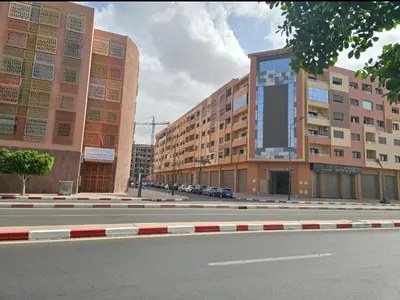 an empty city street with two tall buildings at Luxury apartment in Gueliz Marrakech in Marrakech