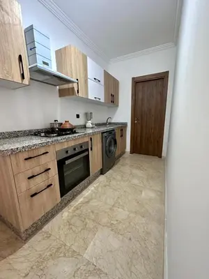 a kitchen with wooden cabinets and a dishwasher at Luxury apartment in Gueliz Marrakech in Marrakech