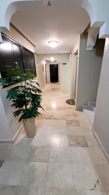 a hallway with a potted plant in a building at Le stratégique a 10mn de l'aéroport face gare Ctm Hivernage in Marrakech