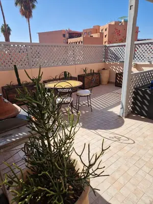 a patio with a table and chairs on a balcony at appartement hyper centre Gueliz in Marrakech
