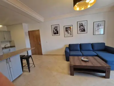a living room with a blue couch and a table at appartement hyper centre Gueliz in Marrakech
