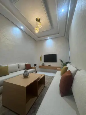 a living room with a couch and a coffee table at IMMOB Basma in Marrakech