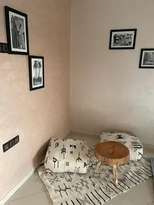 a corner of a room with a table and a bed at IMMOB Basma in Marrakech