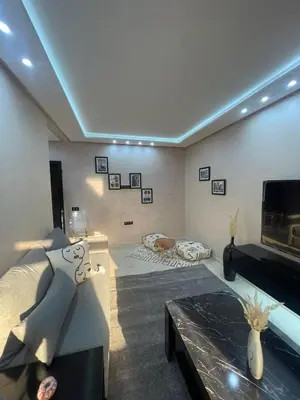 a living room with a couch and a tv at IMMOB Basma in Marrakech