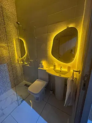 a bathroom with a toilet and a sink and a mirror at IMMOB Basma in Marrakech