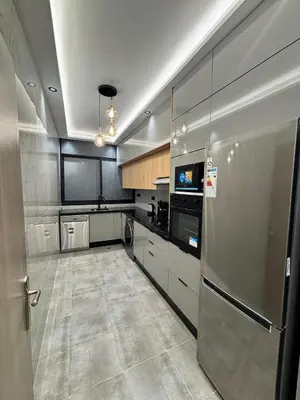a kitchen with a stainless steel refrigerator and a dishwasher at Nice apartment in Cherifia in Marrakech