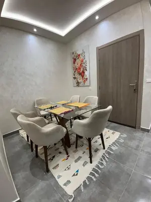 a dining room with a table and chairs at Nice apartment in Cherifia in Marrakech