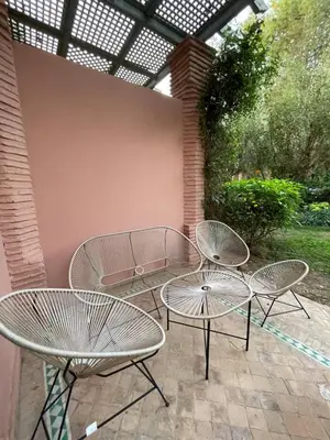 two tables and two chairs on a patio at Dar lala habiba in Marrakech
