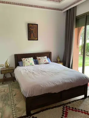 a bedroom with a bed and a large window at Dar lala habiba in Marrakech