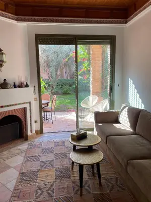 a living room with a couch and a fireplace at Dar lala habiba in Marrakech