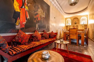 a living room with a couch and a table at Riad Kamal Deluxe in Marrakech