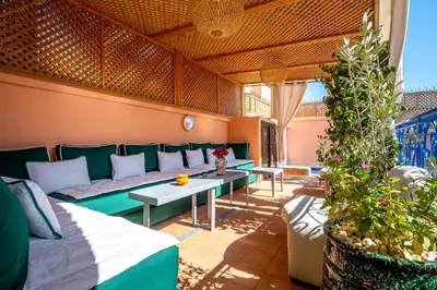 a living room with a couch and a table at Riad Kamal Deluxe in Marrakech