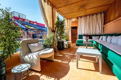 a living room with a couch and a table at Riad Kamal Deluxe in Marrakech