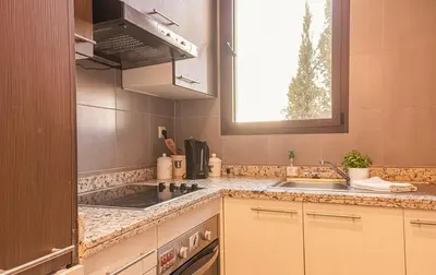 a kitchen with a sink and a stove and a window at Waky Club - Designer Flat in Marrakech