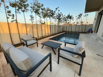 a patio with chairs and a table and a pool at Villa Marrakech karim in Marrakech