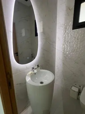 a white bathroom with a sink and a mirror at Villa Marrakech karim in Marrakech