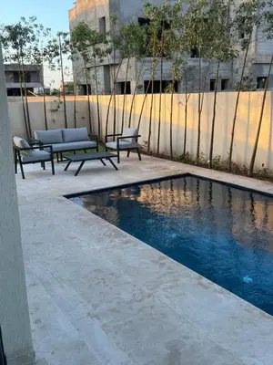 a swimming pool with benches next to a fence at Villa Marrakech karim in Marrakech
