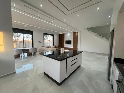 a kitchen with a island in the middle of a room at Villa Marrakech karim in Marrakech