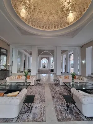 a large living room with couches and a large ceiling at Palais Les Orchidées - Villa de Luxe à 15 minutes du Centre in Marrakech