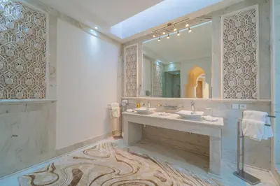 a bathroom with two sinks and a large mirror at Palais Les Orchidées - Villa de Luxe à 15 minutes du Centre in Marrakech